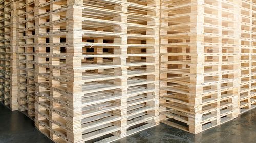 stacked-wooden-pallets-storage-warehouse