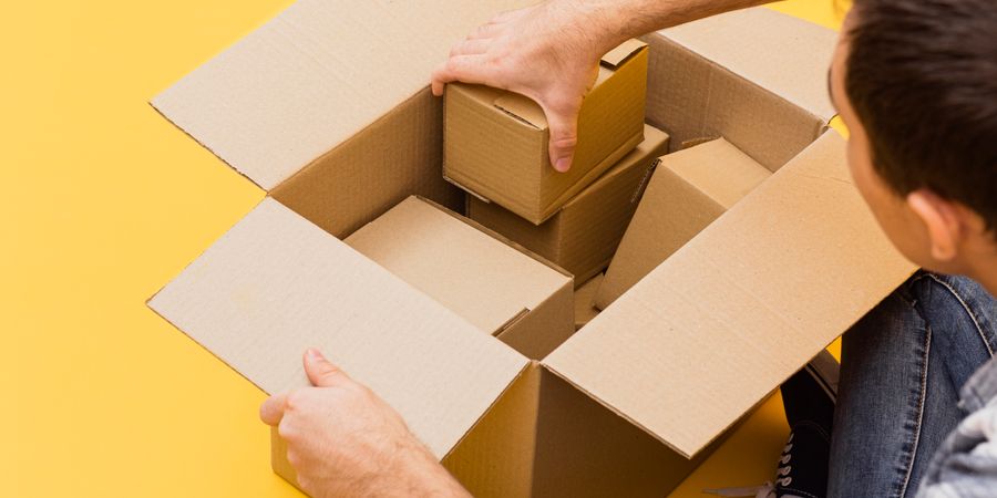 high-angle-man-arranging-delivery-packages